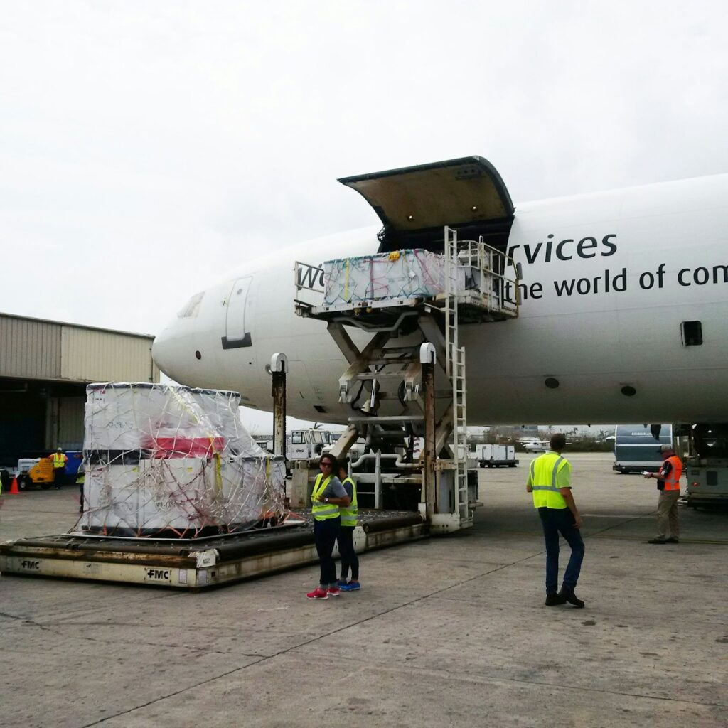 Ground crew beside a cargo aircraft